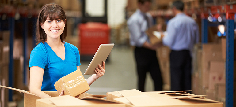 Worker in warehouse pulling items to fulfill an order.