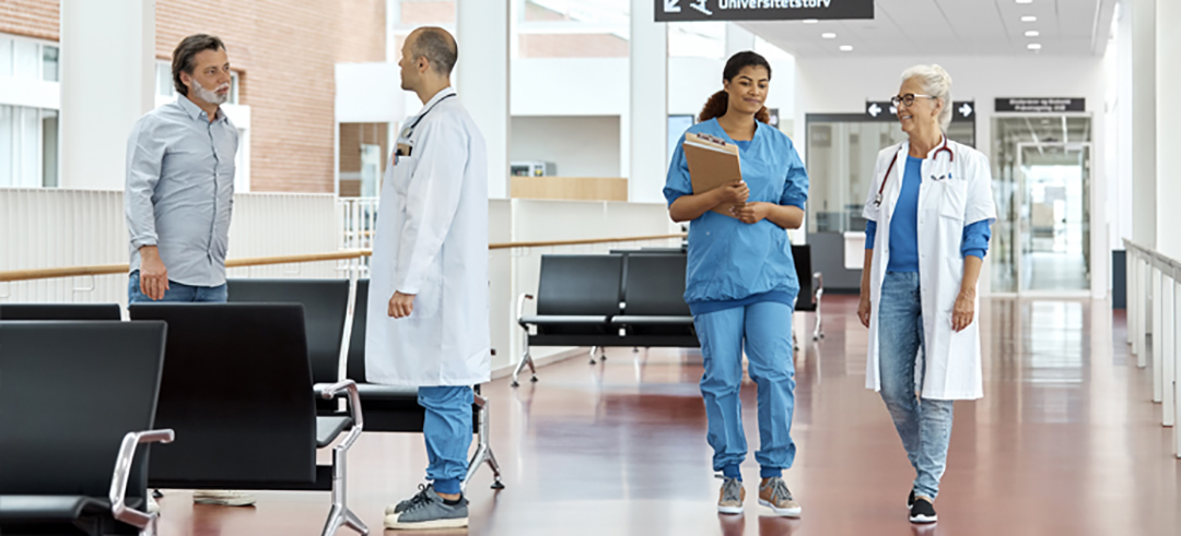 nurses walking down the hall of a hospital